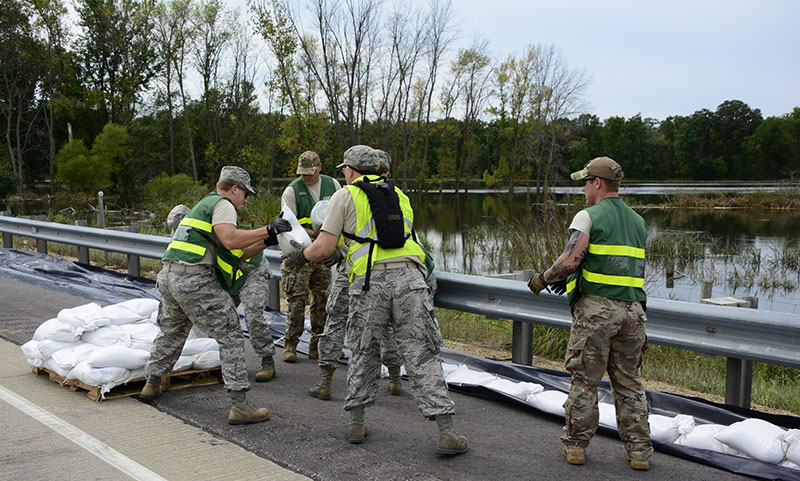 Members of the 115th Fighter Wing provide support by placing sand bags during summer flooding in southern Wisconsin in 2018